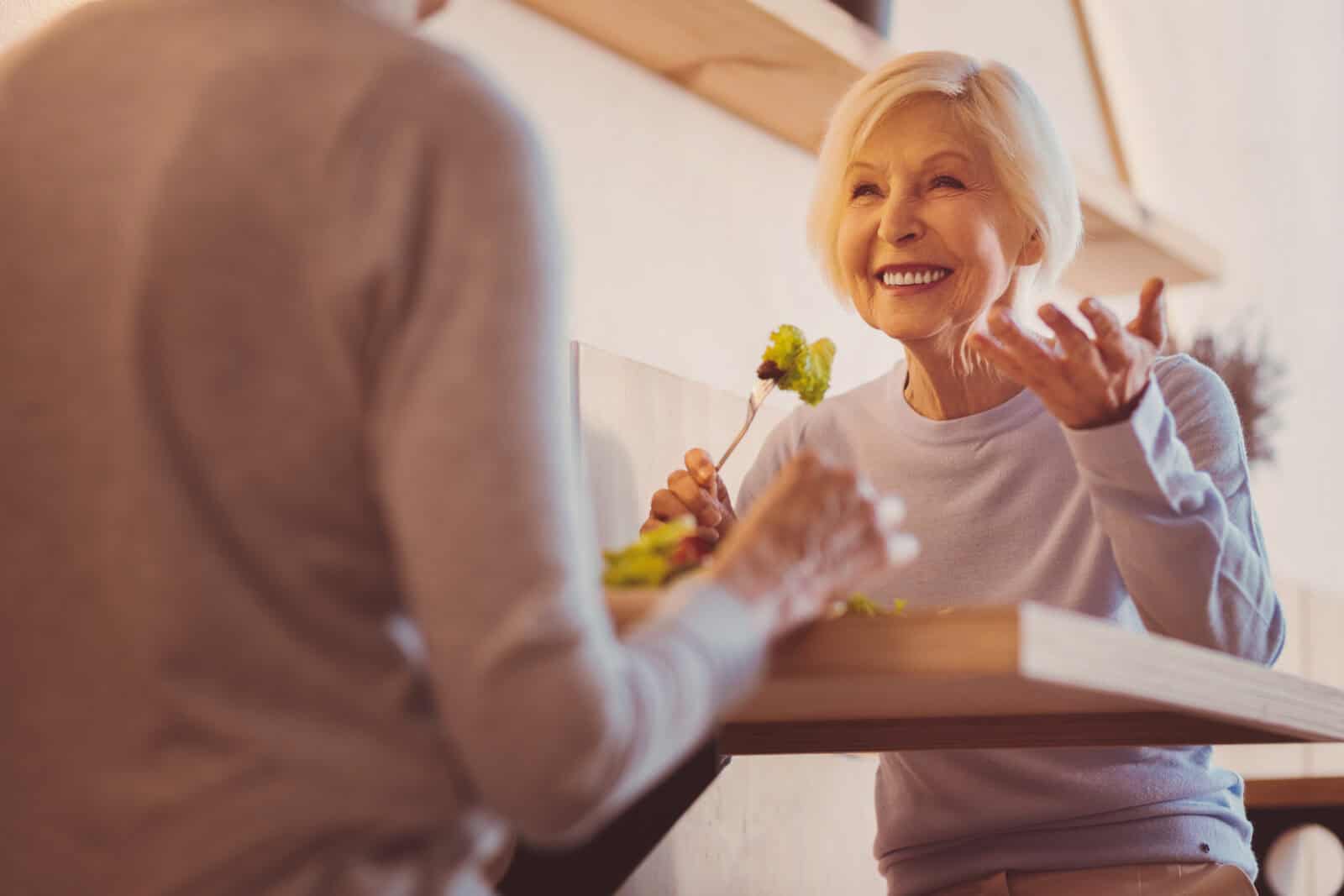 Senior woman smiling in a social setting