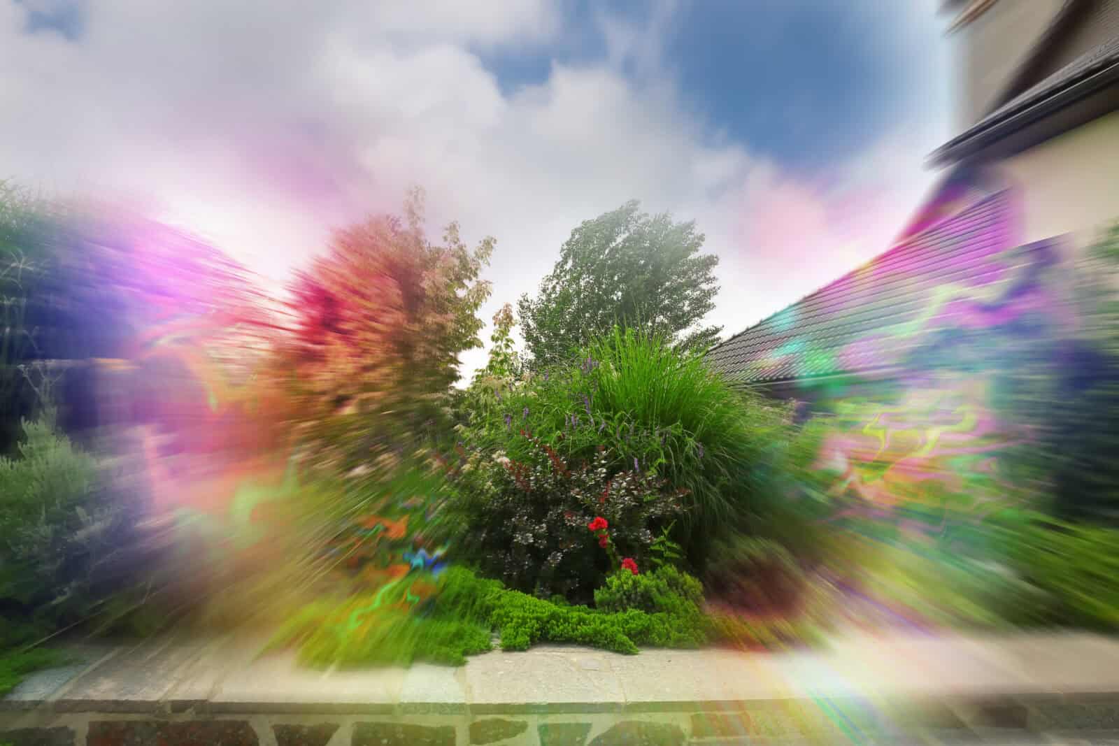 View of garden near house and flashing lights effect. Migraine aura, symptom of disease