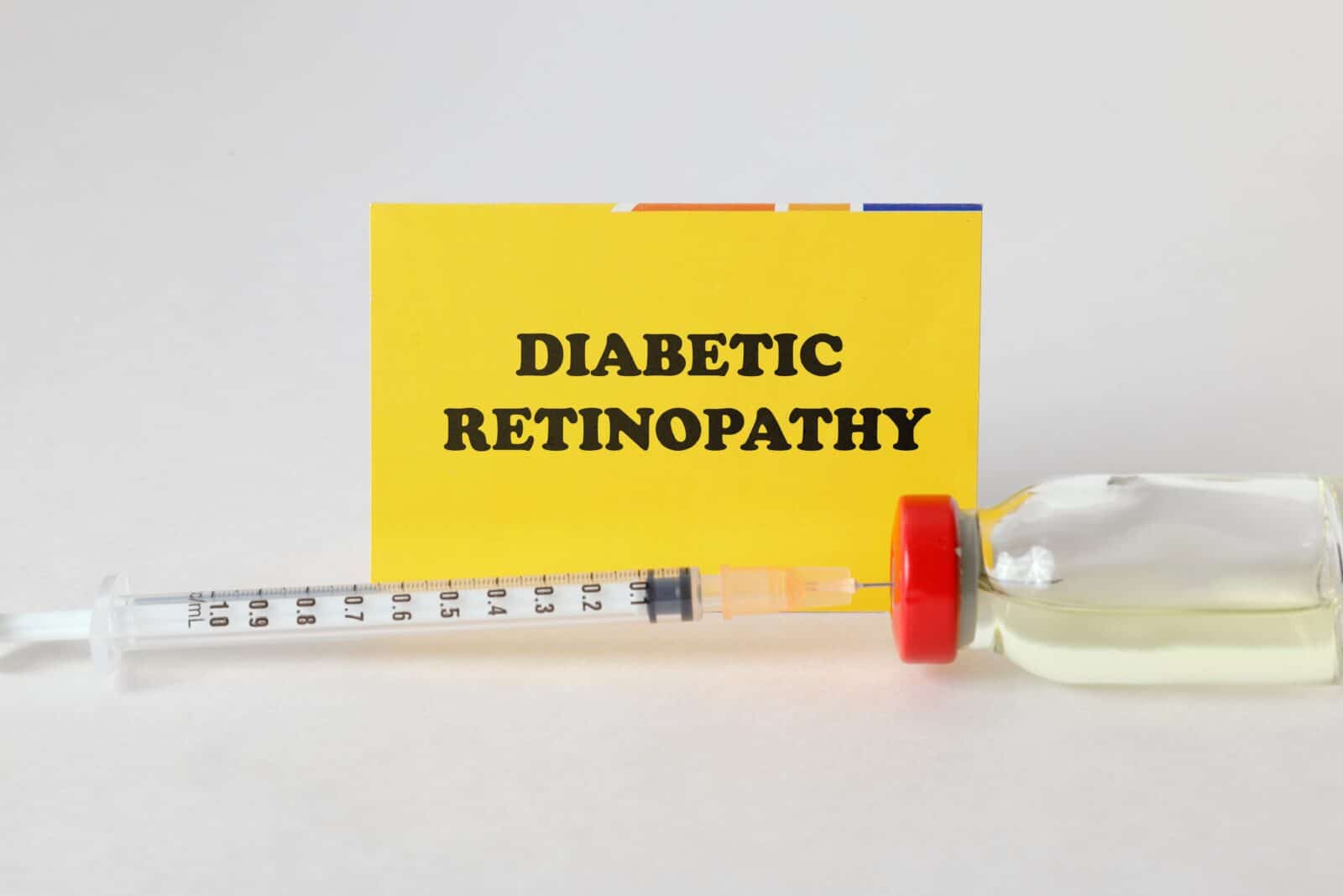 Diabetic retinopathy concept with syringe and vial