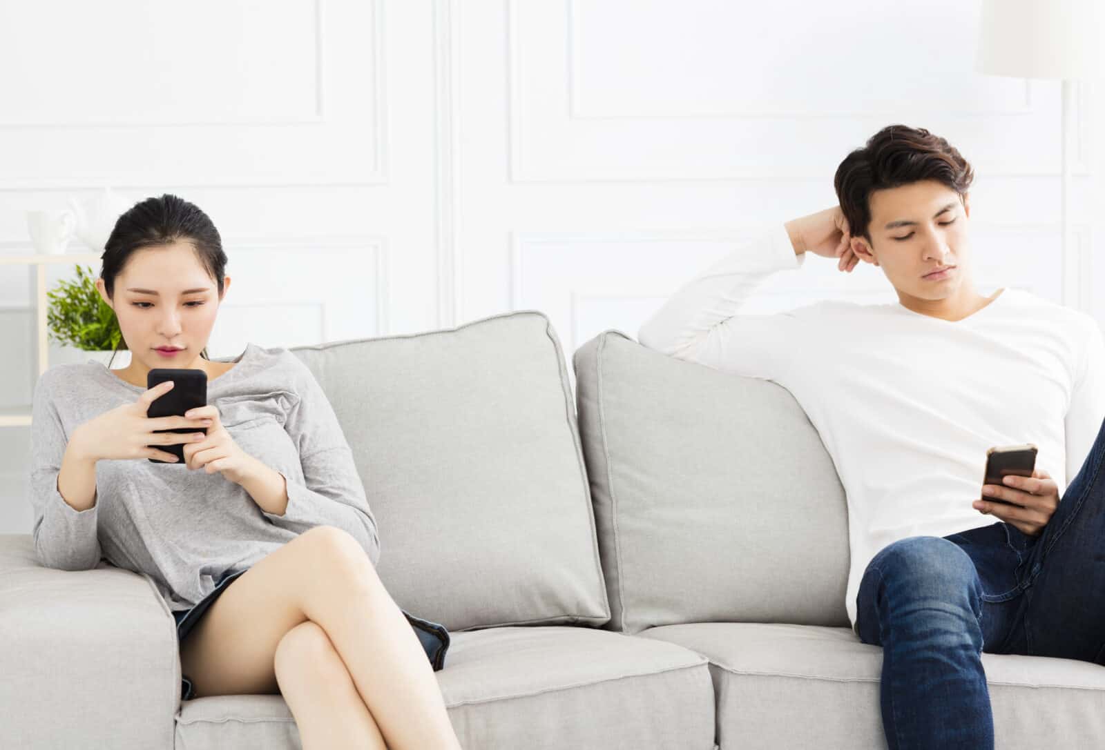 couple using their phones separately
