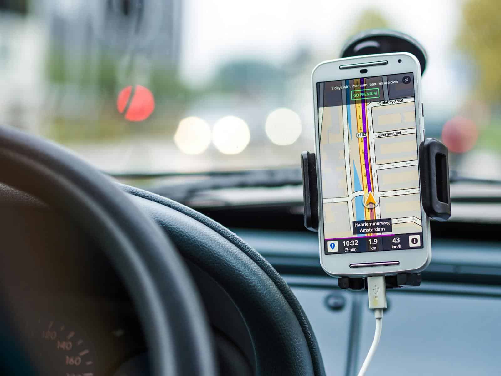 Smartphone mounted in car using GPS for navigation and directions. Navigation Apps