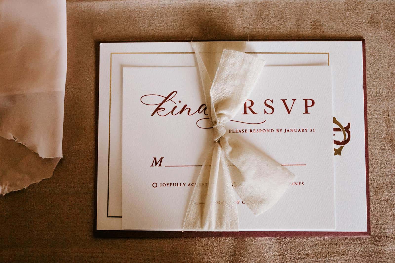Top view of wedding invitation card for guest with RSVP abbreviation requiring respond from invitee