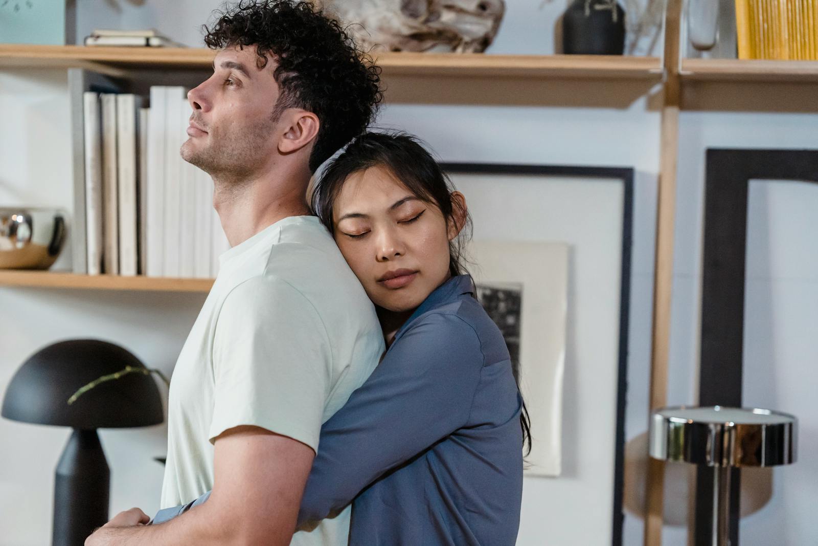 Warm and intimate moment of a couple embracing in a cozy indoor setting.