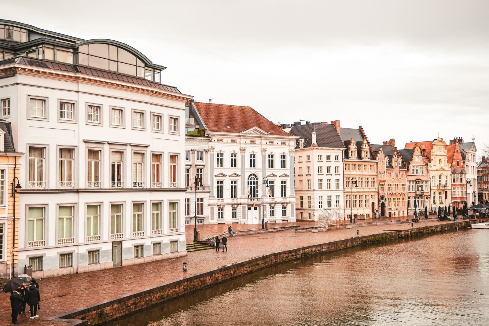 Picturesque view of historic buildings along the Leie River in Ghent, Belgium.