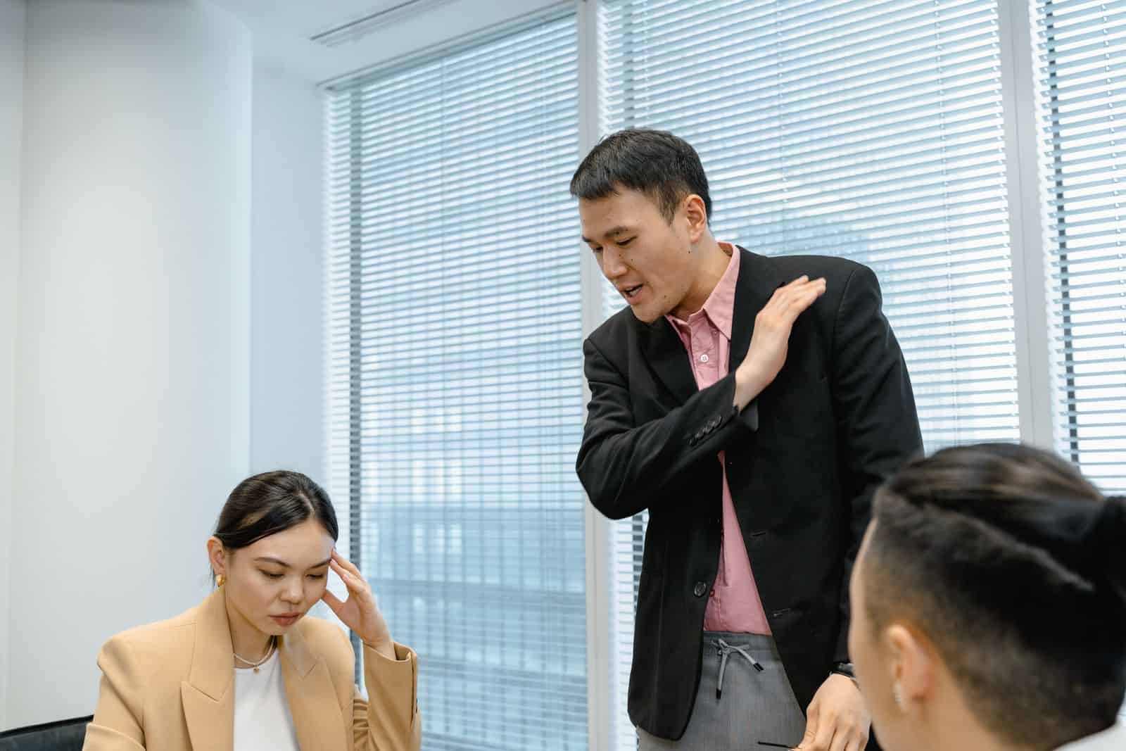 Diverse business team engaged in a serious discussion during a meeting in a modern office setting.