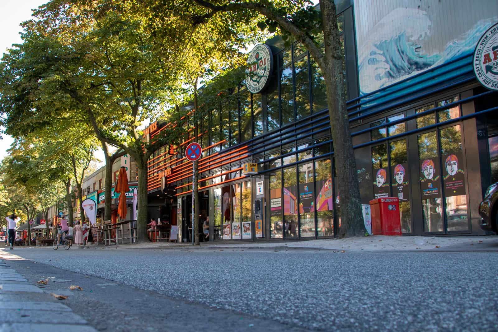 Lively street with modern architecture and trees in Hamburg, Germany.