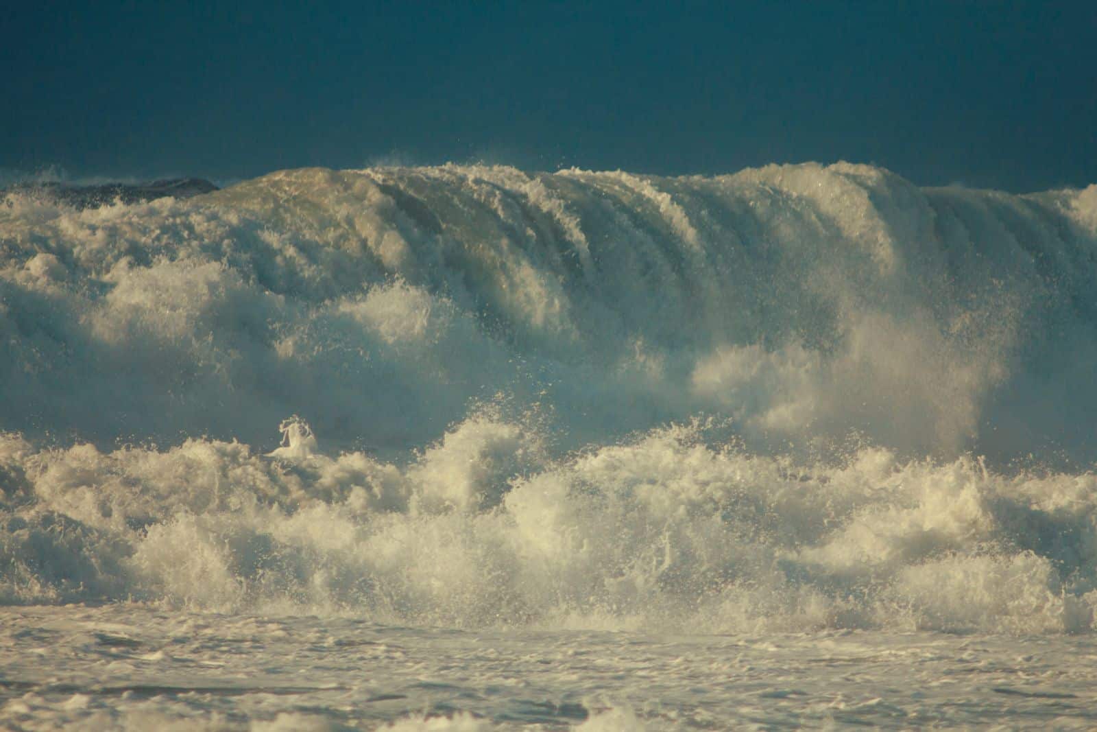 Powerful ocean waves crashing, capturing the force and beauty of the sea.