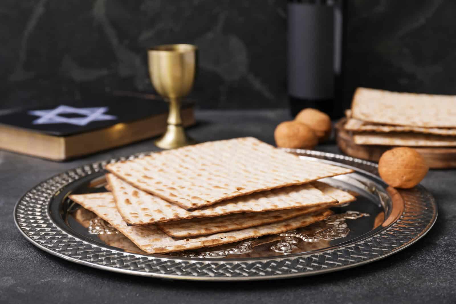 Passover Seder plate with matzo on dark background